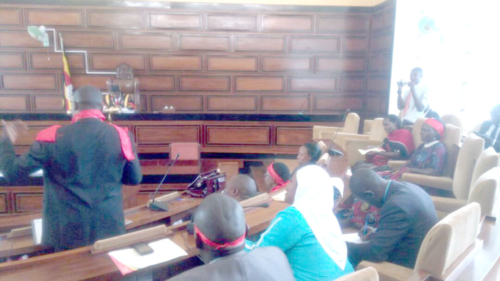 Lord Mayor Erias Lukwago discussing city affairs with councilors at City hall.