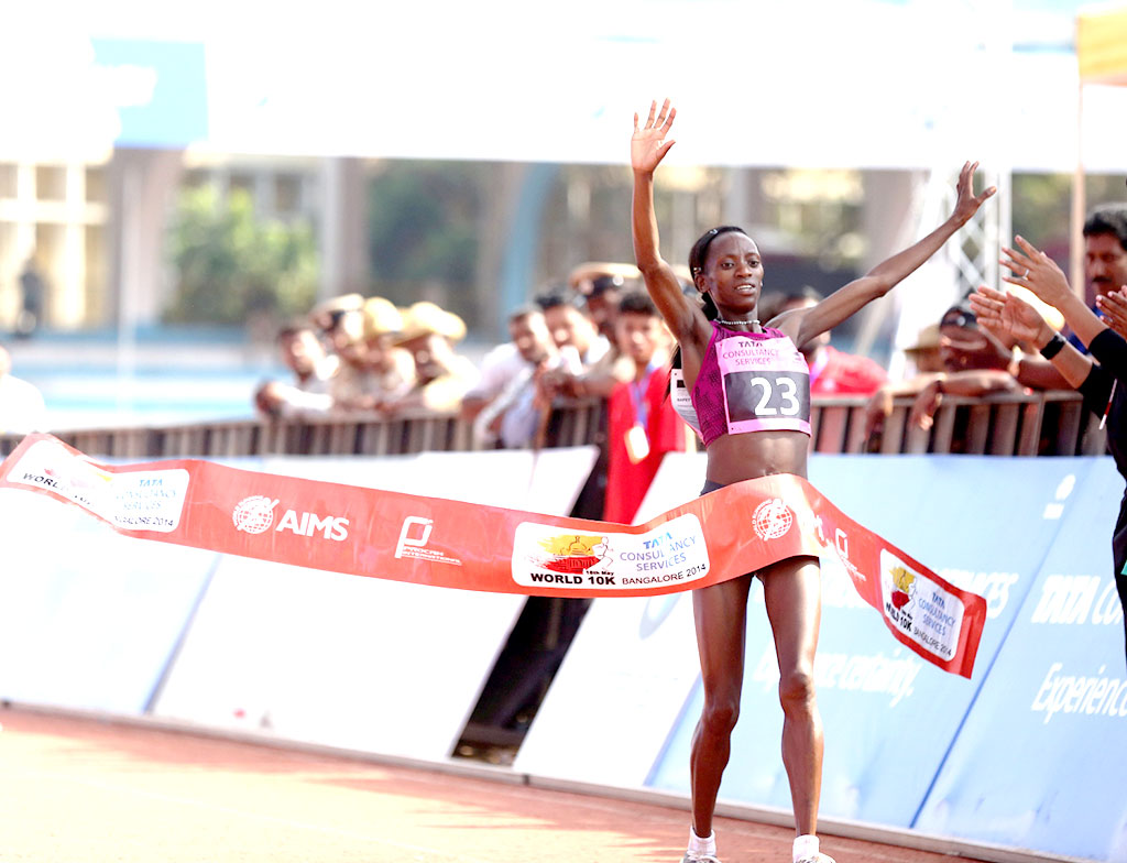 Kenya’s Lucy Kabuu crosses the finish line in 00:31:48 seconds to win the overall women’s title at the TCS World 10K Bangalore 2014.