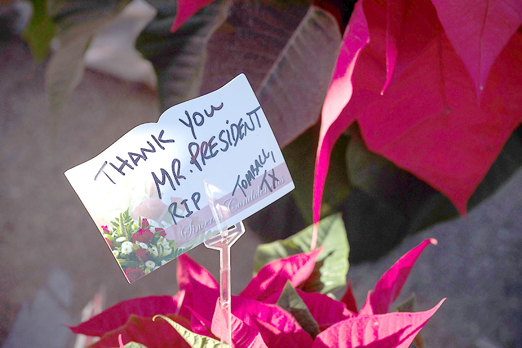 A note at a makeshift memorial in tribute to former US President George H. W. Bush is pictured outside a gated community where Bush lived in Houston, Texas, on December 2, 2018.