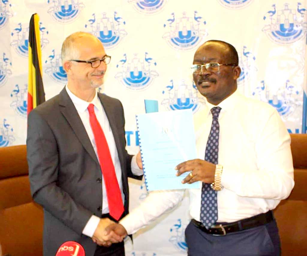 Mr Joel Boutroue, UNHCR Representative in Uganda and Dr. Eng. Silver Mugisha, the Managing Director of NWSC after signing a landmark agreement that will ensure reliable water provision for more than 84,000 refugees 