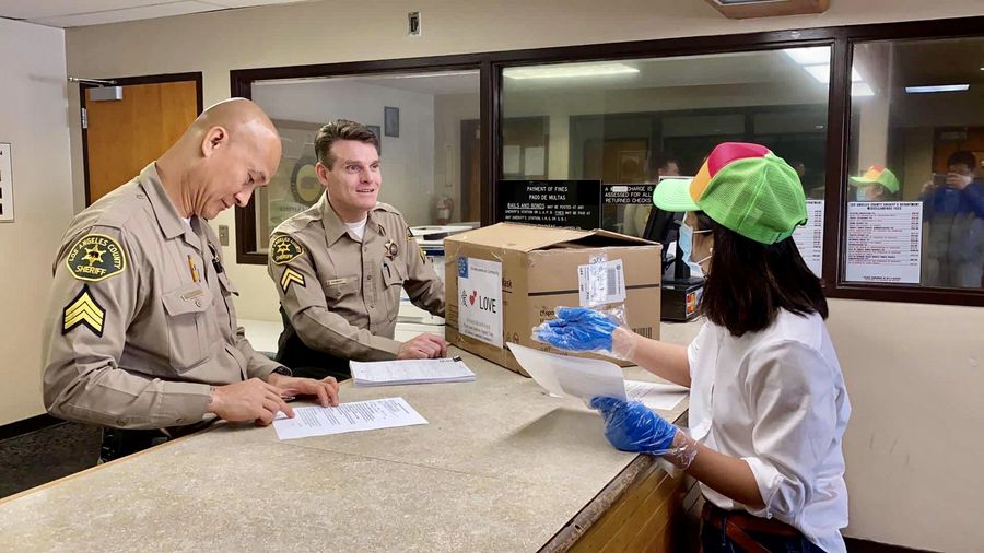 A Chinese American woman from Palos Verdes, Southern California, delivers donations to a local police station in Los Angeles County, the United States, on April 4, 2020. (Photo by Geoff Brown/Xinhua)