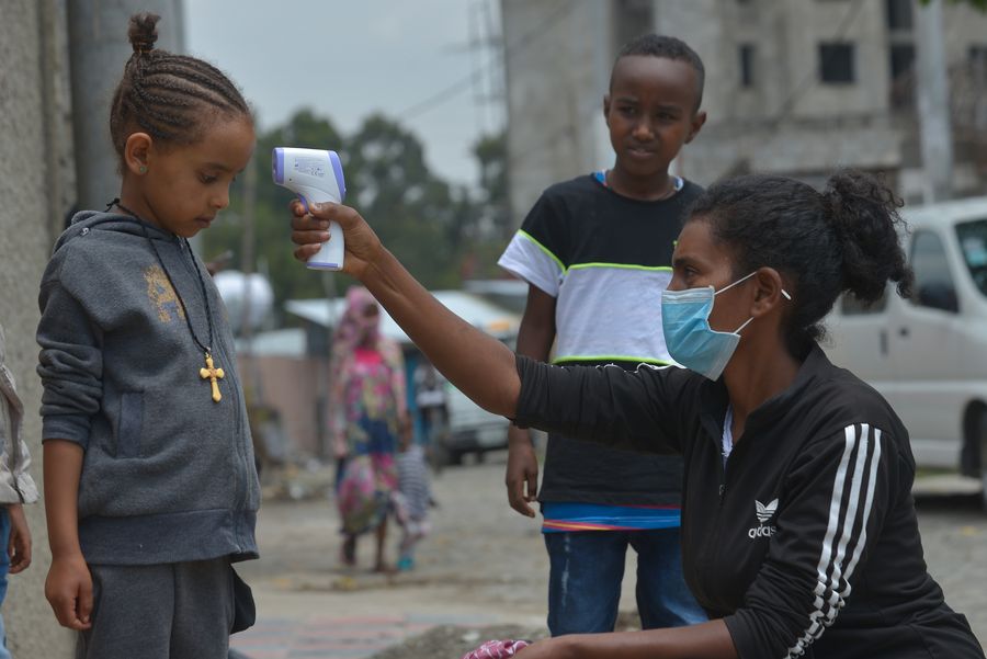 A health worker (R) carries out a door-to-door temperature screening in order to control the spread of COVID-19, in Addis Ababa, capital of Ethiopia, April 20, 2020. (Xinhua/Michael Tewelde)