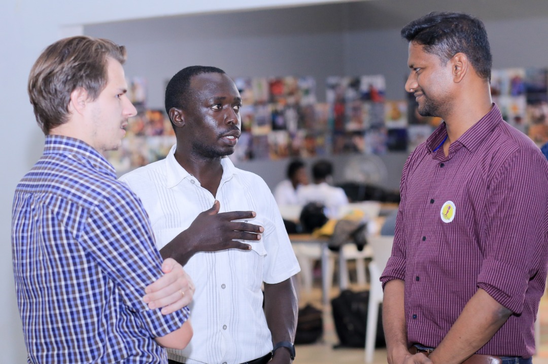 Caption: HiPipo CEO Innocent Kawooya (centre) with Modusbox's Architect Sam Kummary (right) and Crosslake Technologies developer Lewis William Daly (Left) during the Hack Mojaloop event in Kampala last year.