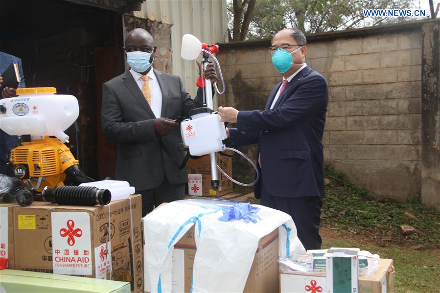 Chinese Ambassador to Uganda Zheng Zhuqiang (R) hands over donated equipment to Vincent Ssempijja, Uganda's minister of agriculture, during a donation ceremony in Kampala, capital of Uganda, on June 10, 2020. China on Wednesday donated an assortment of chemicals and equipment to Uganda in the fight against desert locusts in the east African country. (Xinhua/Zhang Gaiping)