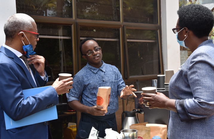      L-R) FAO Representative in Uganda, Antonio Querido, together with the Minister of State for Fisheries, Hon Hellen Adoa (R) listening to Gerald Katabazi, one of the pioneer members of the YIYA initiative, at the launch of Round Two, at Uganda Media Center