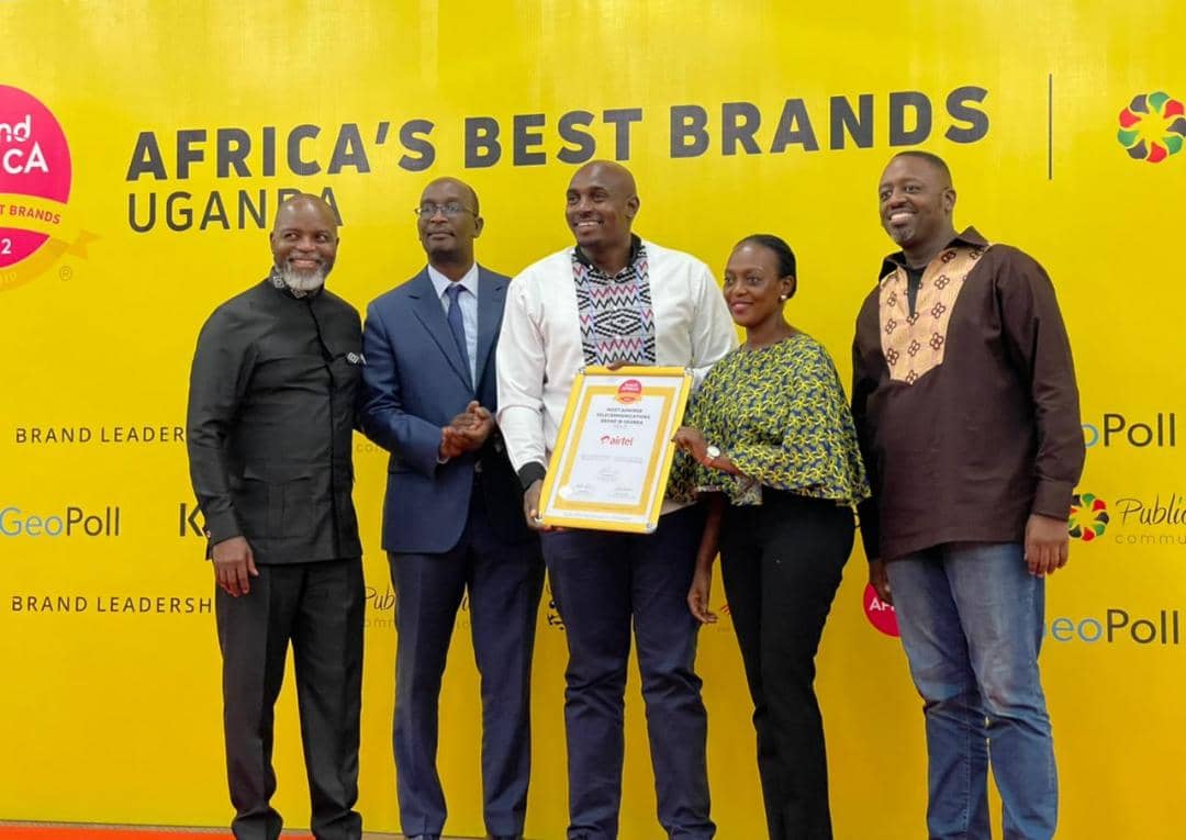 Henry Njoroge (c), Head of marketing at Airtel Uganda, Faith Bugonzi (2nd R), Acting Brand Strategy Manager at Airtel Uganda, Thebe Ikalafeng (L), Founder and Chairman of Brand Africa and Brand Leadership having a photo moment after receiving the accolade as the most admired Telecom brand in the 2022 Brand Africa Survey.