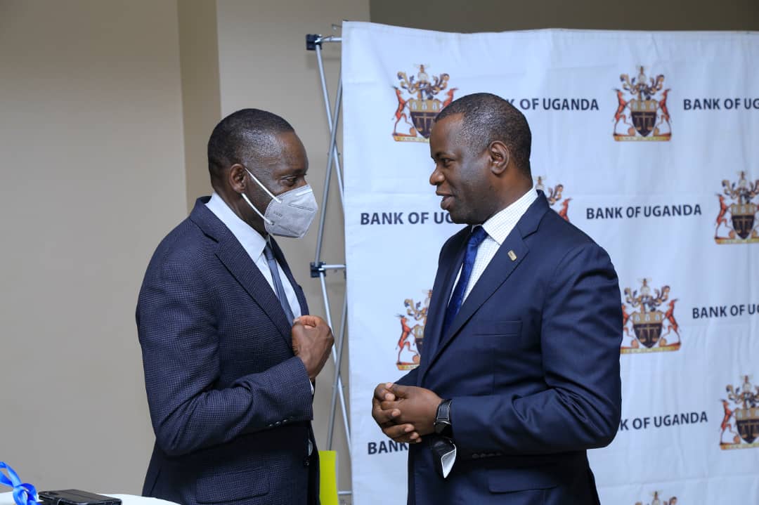 Bank of Uganda Deputy Governor Michael Atingi-Ego (L) and I&M Bank Uganda’s Executive Director and Chief Operations Officer Sam Ntulume.