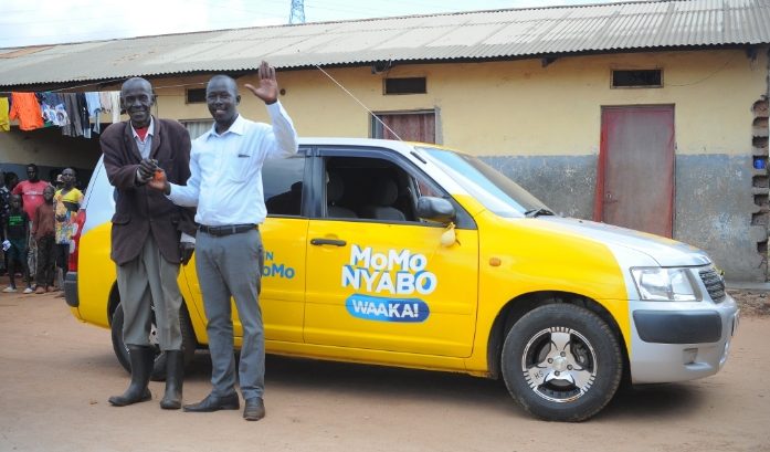 Philip Opio hands over the keys to the Toyota Succeed car to his son having emerged winner during the draw show which airs on NBS TV and Bukedde TV every Thursday-2