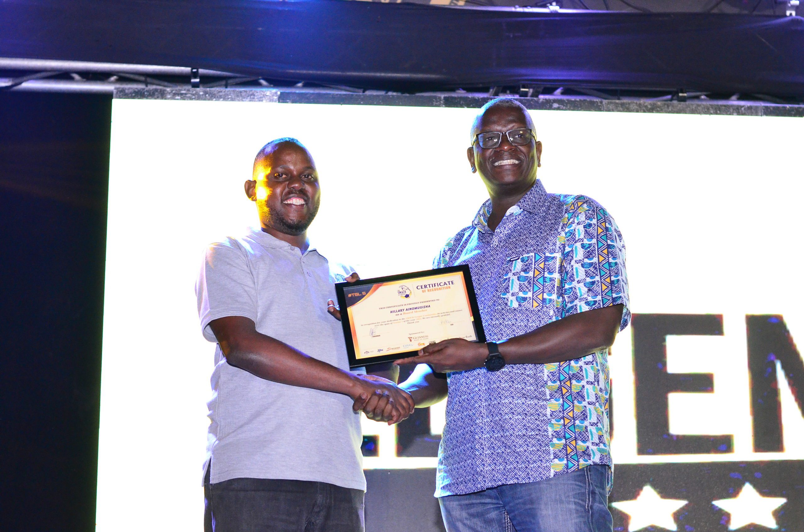 7819 Managing Director UBL Andrew Kilonzo handing over a certificate to SMACK League CEO Hillary Ainomugisha at the finale.