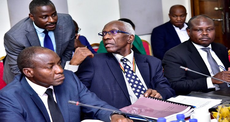 Auditor General, John Muwanga (C) consults one of his staff during the committee meeting