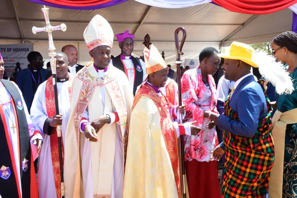 Deputy Speaker Thomas Tayebwa shares a light moment with new North Karamoja Diocese Bishop (PHOTO/Courtesy).