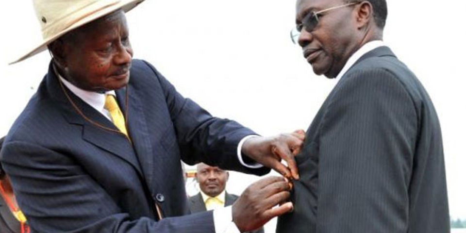 A file photo of President Museveni decorating Prof. Mukiibi (R) to appreciate his contribution in the education sector.