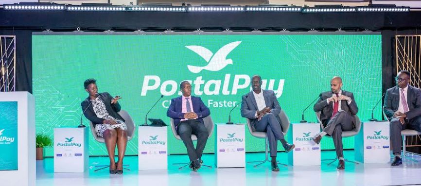 L-R: Mildred Tuhaise, moderator, Jim Muhwezi, Manager Operations & Projects, Posta Uganda, Patrick Oketa, ED, Financial Sector Deepening Uganda, Amol Wagle, Vice President and Head of Partnerships, Eurogiro and Julius Kakeeto, MD/CEO, PostBank on a panel during the launch of the PostalPay app in Uganda. 