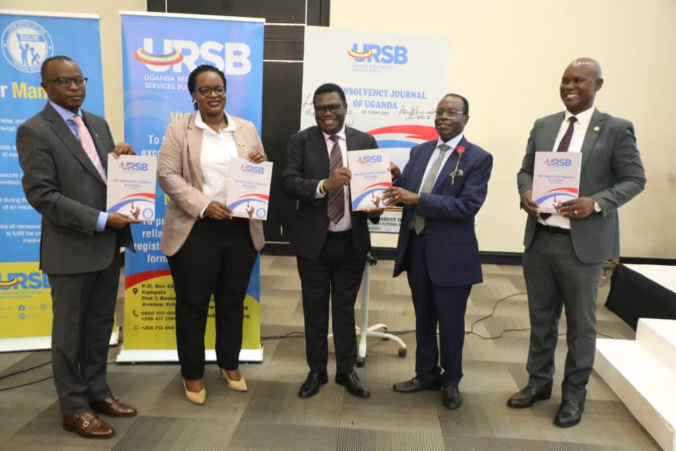 L-R Uganda Law Society President Bernard Oundo, Registrar General, Mercy K. Kainobwisho, Hon. Norbert Mao,...ster of Justice & Constitutional Affairs & Prof. Stephen Nkundabanyanga display the Insolvency Journal during the training