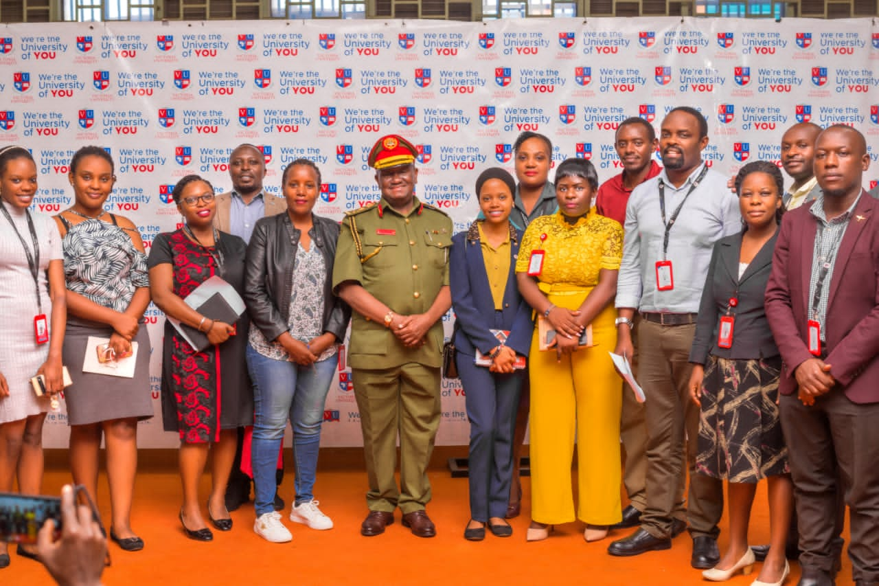 Brig-Gen Kulaigye takes a group picture with the Students and Faculty