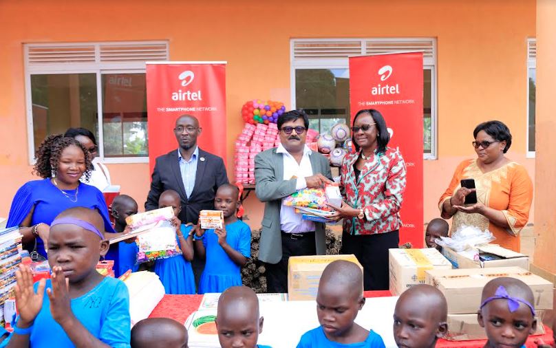 manoj murali (back 3rd R), Airtel Uganda Managing Director, Ms. Olive Birungi Lumonya(back 2nd R), the Board Chairperson at Uganda Women’s Effort to Save Orphans (UWESO), David Birungi (back 3rd L), Public Relations Manager at Airtel Uganda with other representatives from UWESO at the donation of assorted food, household and personal effects items to Masulita Children’s Home. The donation was worth UGX55 million.