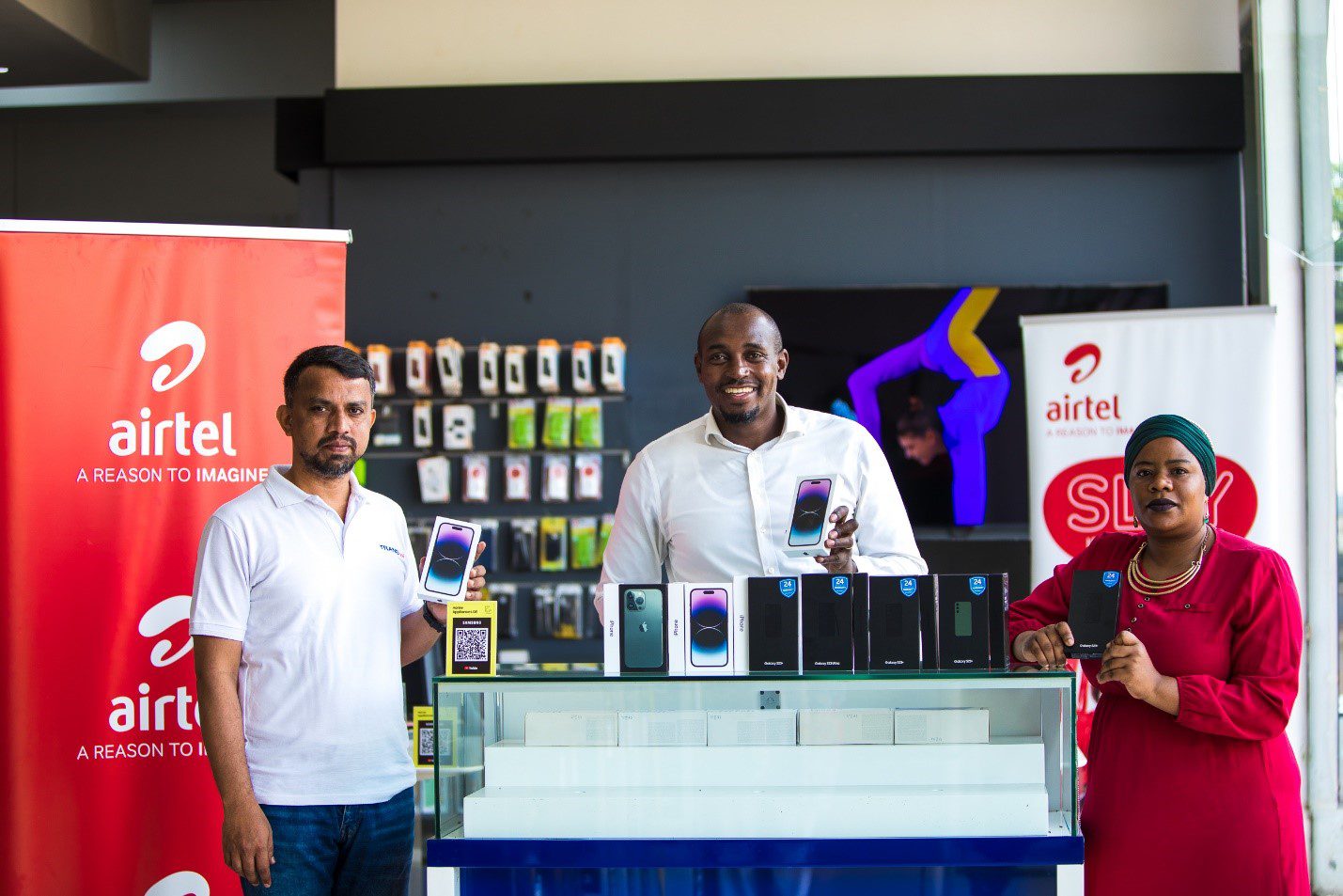 Right to Left: Siddaraju Head of Sales Transtel, Henry Njoroge Marketing Director Airtel Uganda and Ms. Joweria Nabakka Head Data and Devices Airtel Uganda with the iPhone 14, iPhone 14+, iPhone plus, Samsung S23+ and Samsung S23 Ultra.