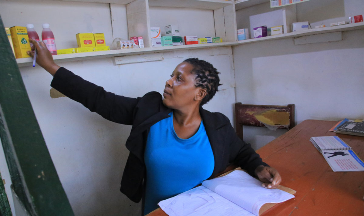 Ms. Shalon Asimwe, a gender-based violence survivor taking stock of medicines in her drug shop which she had temporarily closed.