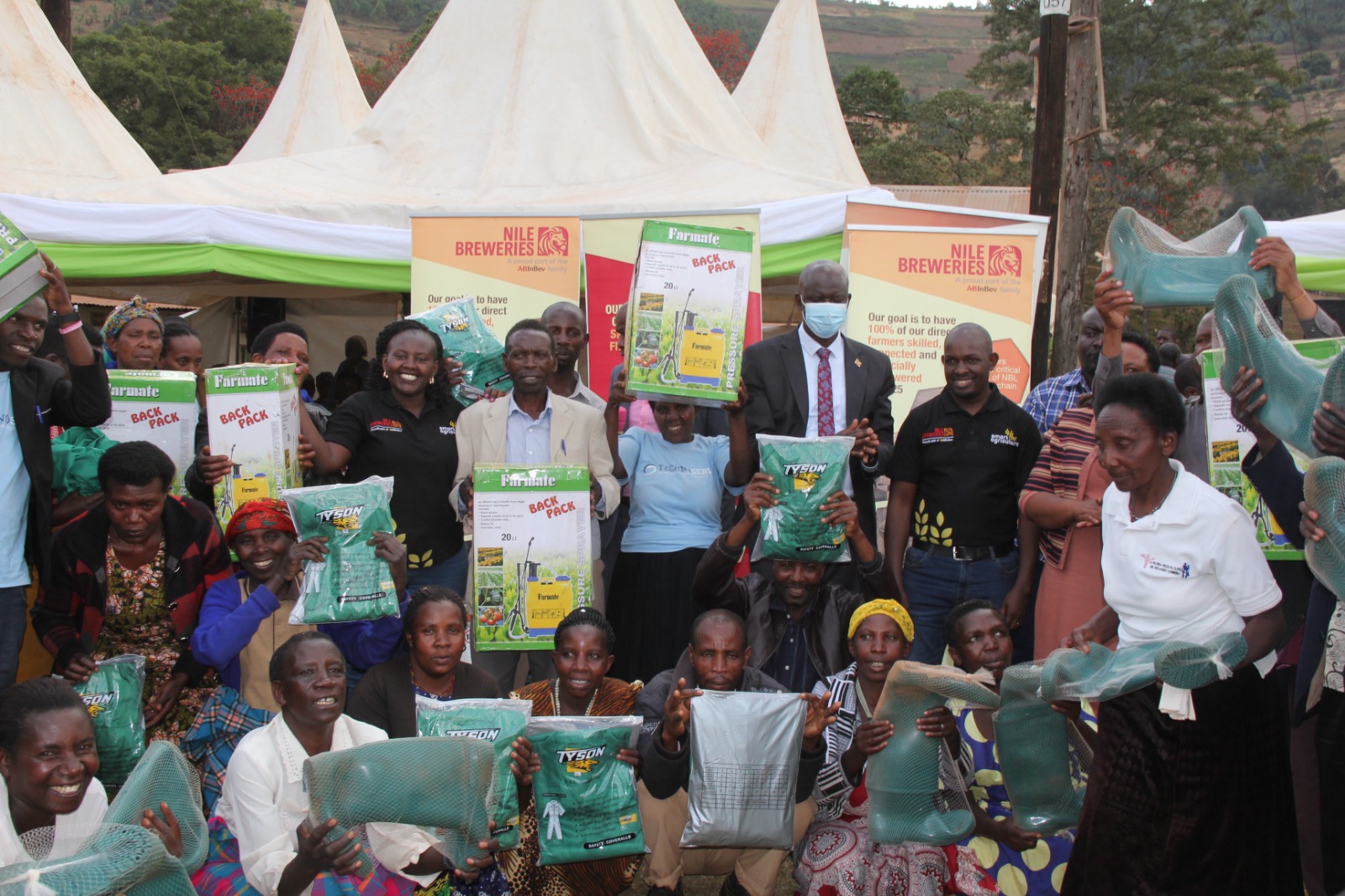 Barley farmers in Kabale District pose for a photo with Emmanuel Njuki the Nile Breweries Limited (NBL), Head of Legal and Corporate Affairs, Clare Asiimwe the NBL Corporate Affairs Manager and Nelson Nshangabasheija the LC5 Chairman in  Kabale District after a financial literacy skills training by NBL in the region. NBL empowered over 1000 barley farmers in Kabale and Rubanda Districts with financial literacy skills.