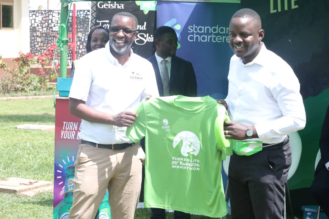 Unilever Uganda’s Home Care Category & Channel Development Manager, Emmanuel Kabugo (right) shares a photo moment with  Amos Wekesa ,the Director of Equator Hikes, the organisers of the marathon.