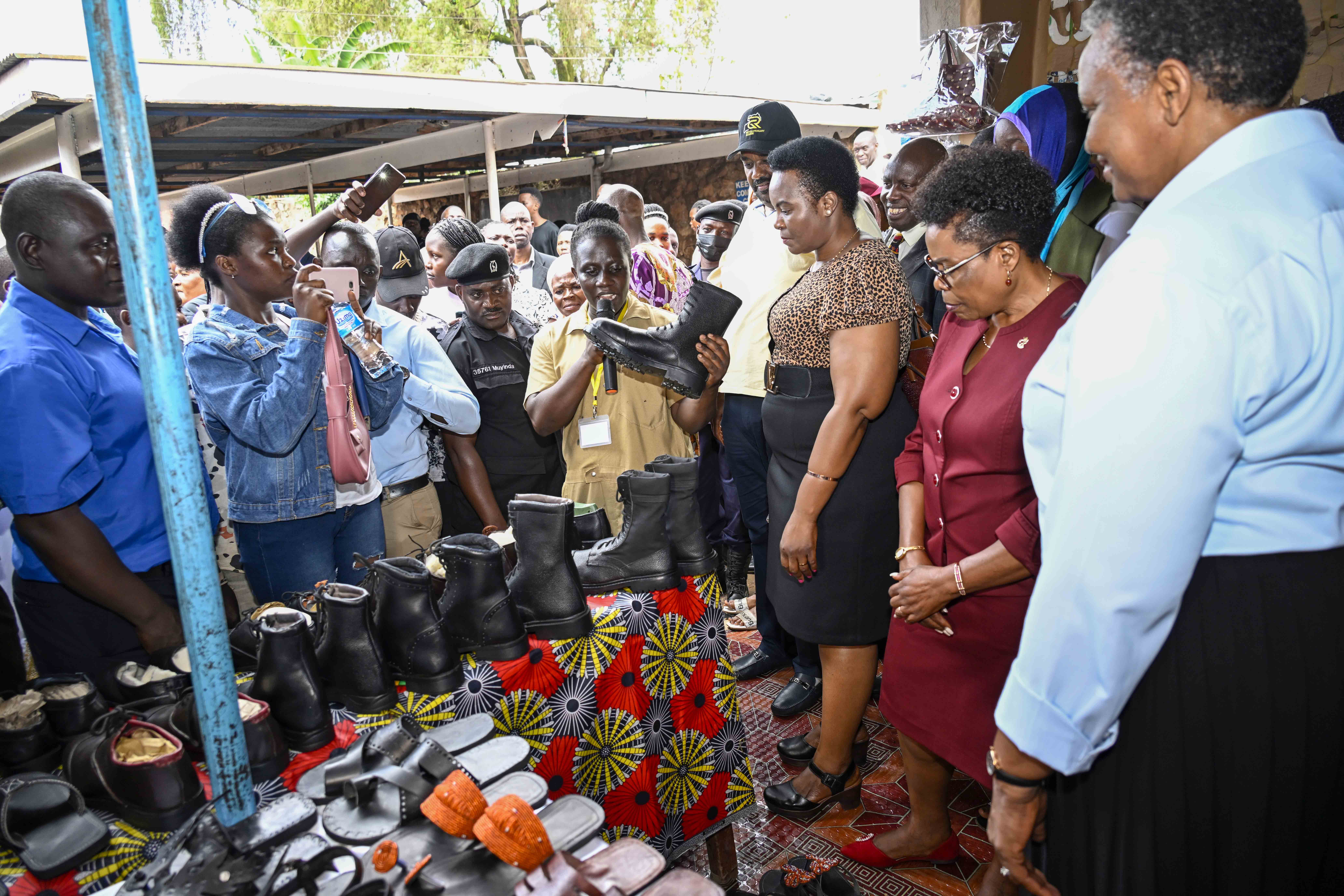 The State Minister for Lands, Housing and Urban Development (Lands)Persis Princess Namuganza, Namuganza , Inspector General of Government Beti Olive Namisango Kamya, the chairman of National Resistance Movement (NRM) Kiruhura District and the National Coordinator Revolutionary Guard Nzaire Sedrack Kaguta, the Presidential Initiative on skilling the Girl/Boy (PISG/B) Child project Director Faith Katana Mirembe and parents admire the products of the leather students during a show casing of work for students at the PISG/B Nakulabye center in Kampala on 19th September 2023. Photo by PPU/ Tony Rujuta.