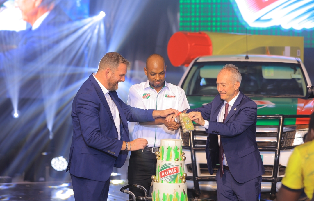 The Castrol,  East Africa General Manager Ed Savage, (Left)  RUBiS Energy Uganda Country Manager, Olivier Gatera (Centre) and Rubis Enegry East Africa/ Managing Director Rubis Energy, Jean Christian Bergeron (Right) cut cake to celebrate the RUBiS - Castrol partnership Launch.