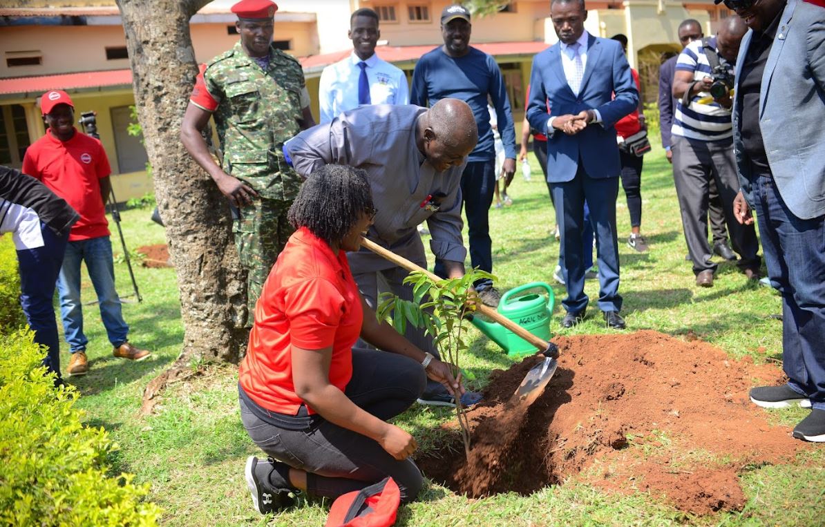 Helen Nangonzi Basuuta - Absa's Marketing & Customer Experience Director plants a tree at Mwiri with Gen. Edward Katumba Wamala - Minister of Works & Transport