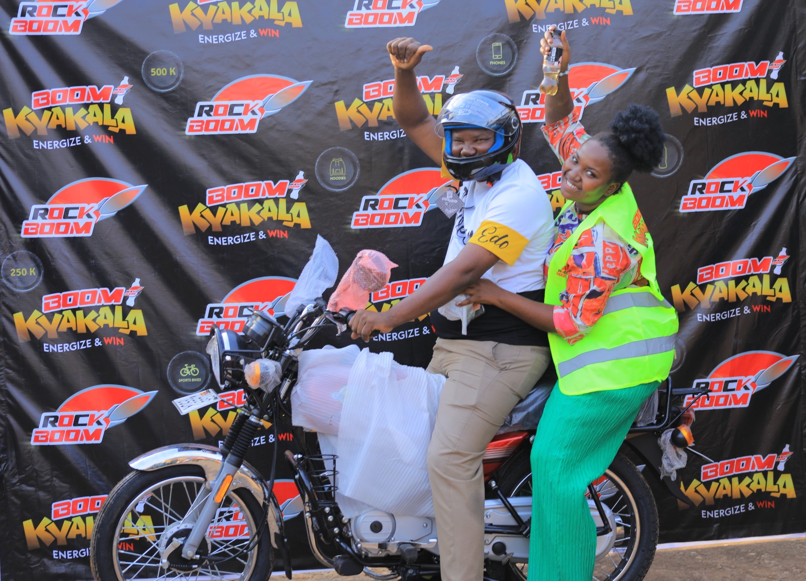 Iradukunda Lixa (lady) winner of motorbike celebrates with father.