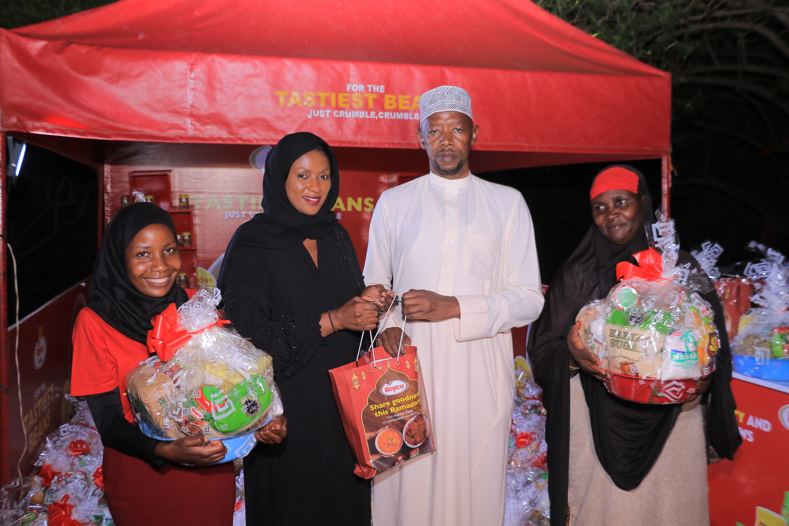 Grace Nandawula, (Second left) Nutrition Category Manager at Unilever hands over a basket with items donated to the muslim community to Executive Imam at Kibuli Mosque, Sheikh Mutyaba Abdusalam during the culmination of the 'share goodness' campaign.