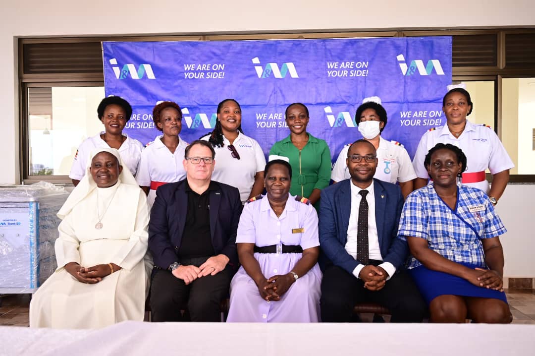 I&M Bank executive members: Robin Bairstow, CEO and Annette Nakiyaga Head of Marketing and Corporate Communications pose for a photo moment with the staff members at St Francis Nsambya Mother Kevin Ward after the donations.