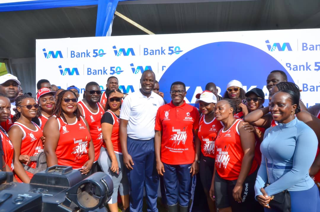 The Katikkiro of Buganda Owek. Charles Peter Mayiga (center), Executive Director & Chief Operations Officer of I&M Bank Sam Ntulume (left), and other I&M Bank staff pose for a photo during the Kabaka Birthday Run in April.