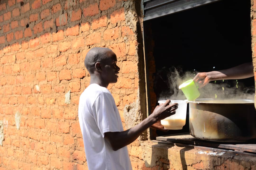 One of the students getting Porridge from the Kitchen at Barakala seed Secondary School