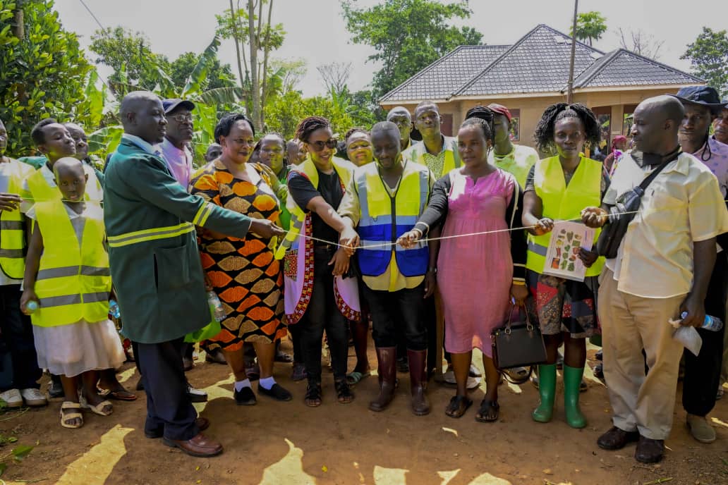 Dr. Hillary Musoke Kisanja, Private Secretary to H.E the President, cuts the ribbon to officially launch the Trends Demonstration Farm in Kasanje Town Council, Wakiso District, Uganda. This marks a significant milestone in promoting President Museveni's 4-acre model vision for improved household income and food security in the country