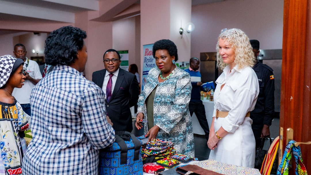 Minister of Gender, Labour and Social Development, Betty Amongi (left) and European Union Head of Cooperation, Caroline Adriaensen (right), inspect stalls of Micro, Small and Medium-Sized Enterprises (MSME) exhibitors during the MSME Day celebrations in Uganda. They are seen engaging with entrepreneurs and learning about their products and services, demonstrating their commitment to supporting the growth and development of MSMEs in Uganda.