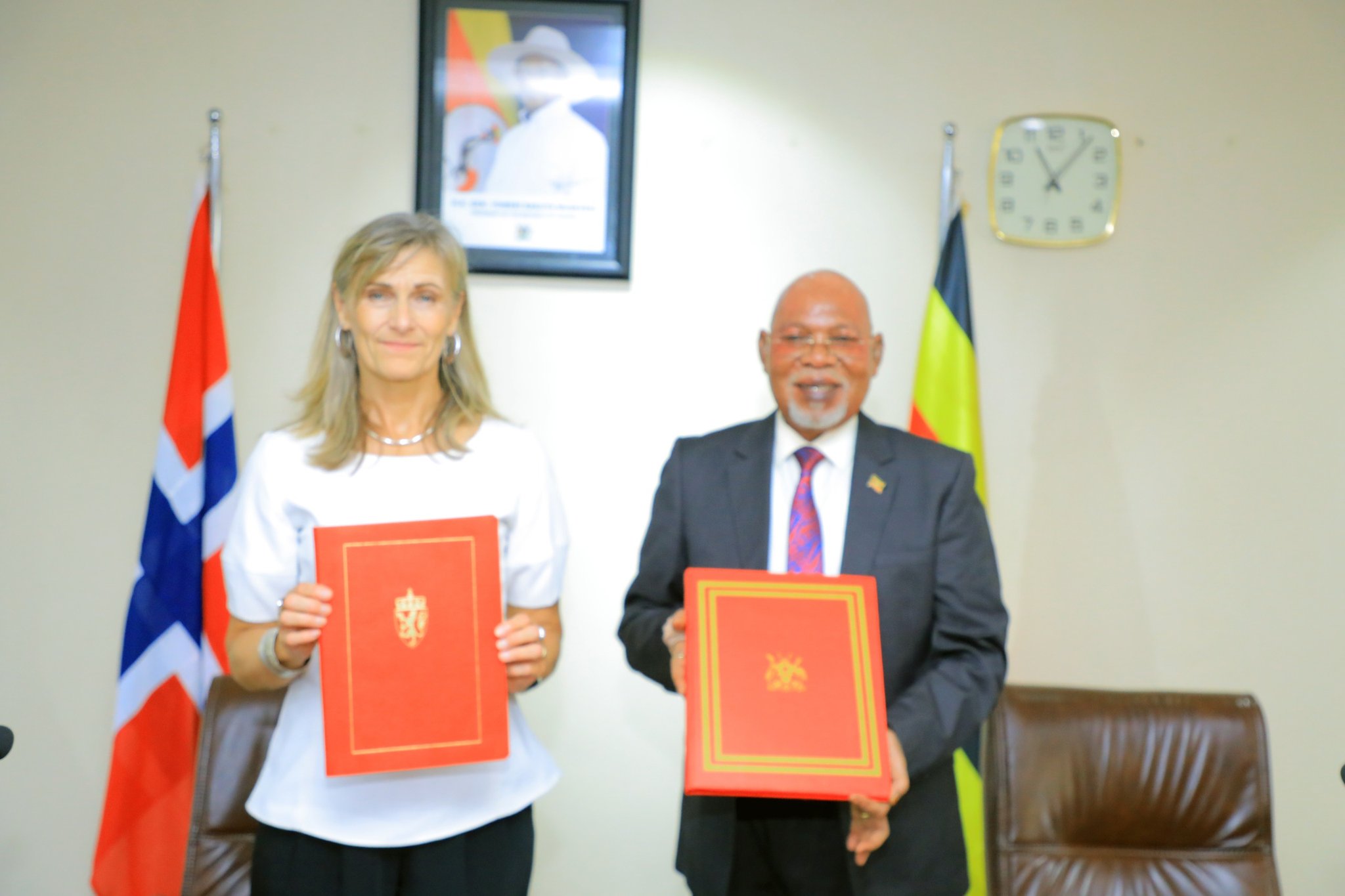 Uganda's Minister of Foreign Affairs, Gen. Odongo Jeje Abubakhar (right), and Norway's Ambassador to Uganda, Her Excellency Kristin Hermansen (left), exchange signed copies of the Memorandum of Understanding (MoU) on Political Consultations at the Ministry of Foreign Affairs in Kampala, Uganda, solidifying a new chapter in bilateral relations between the two nations.