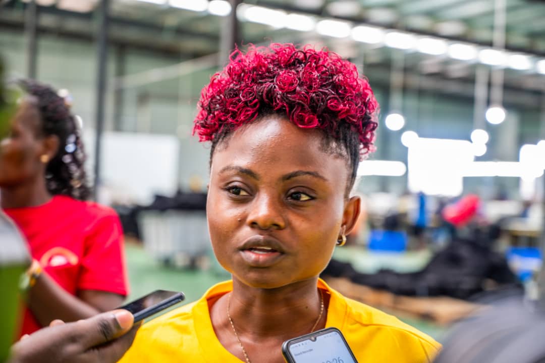 Sandra Nabukwaasi, a young woman from Bulambuli, operates a hi-tech machine at the textile facility in Mbale Industrial Park. Sandra honed her tailoring skills at the park, despite financial constraints that hindered her formal education. She now works proudly at the factory, sustaining herself and even saving to invest in a rice plantation.