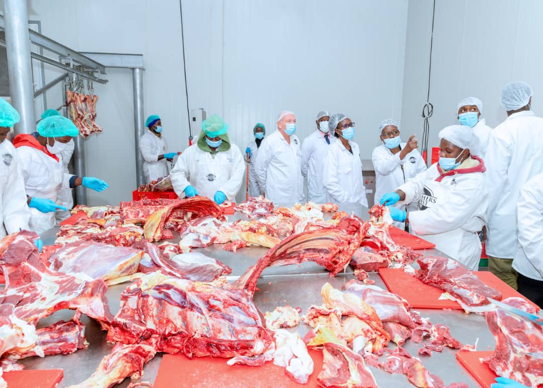 Here is a possible photo caption:"Minister of Finance in charge of Investments, Evelyn Anite, tours the state-of-the-art meat processing facility at Ranchers Finest in Kawempe, Kampala District. She is seen here being shown around by Collins Nyanja, CEO of Ranchers Finest, as she learns about the company's operations and commitment to producing high-quality meat products for both local and international markets.