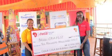 Fiona Kemigisha, the Ag Channel & Trade Marketing Manager Coca Cola Beverages Uganda hands over sponsorship towards this year's Bell ObaFest