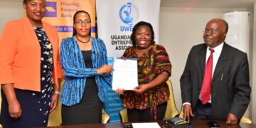 The Executive Director of Housing Finance Bank Peace K. Ayebazibwe (Second left) and Connie Kekihembo, CEO of UWEAL(third left) pose for a  group photo after signing an agreement between Housing Finance Bank and UWEAL (PHOTO/Courtesy).