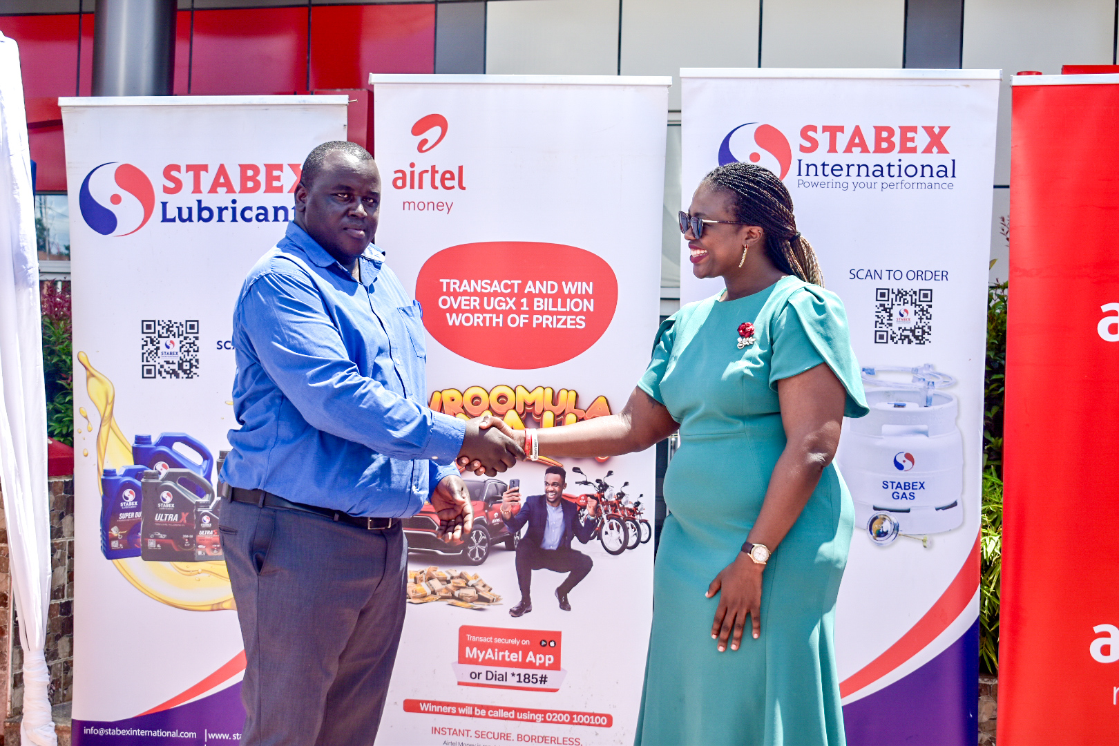 Airtel Money and Stabex International seal partnership: Hope Ekudu, Airtel Money Operations Head (left), shakes hands with Justus Kiptoo, General Manager of Stabex International, at the launch of their collaboration aimed at driving cashless transactions and digital financial inclusion in Uganda