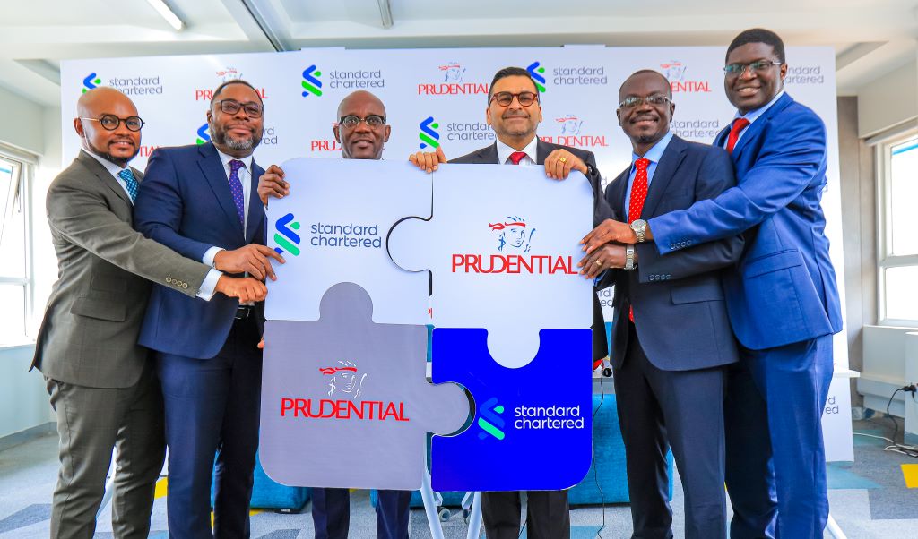 CEO of Prudential Africa, Emmanuel Mokobi (R), Standard Chartered Bank CEO, Mr. Sanjay Rughani(C), the CEO of Prudential Uganda, Mr. Tetteh Ayitevie(R) having a photo moment after announcing a strategic partnership between Standard Chartered Bank Uganda and Prudential Uganda aimed at deepening access to financial services and providing long-term financial security solutions to customers.