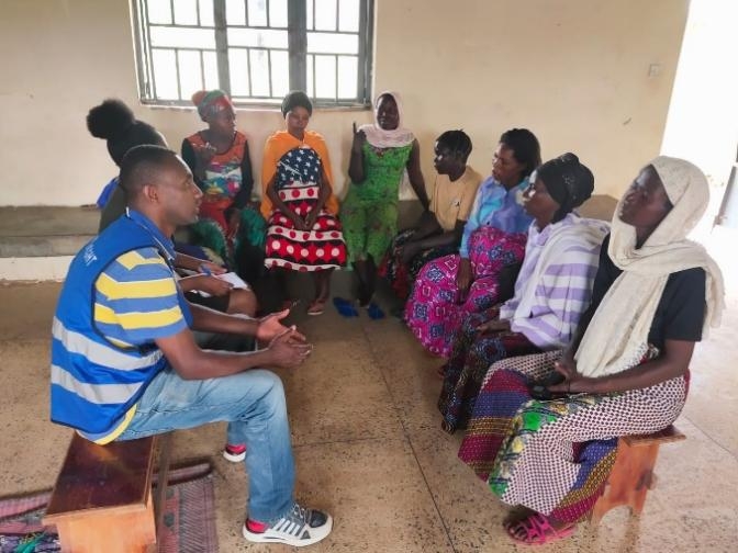 Alight GBV case worker engages in a focus group discussion with Kinyabwisha-speaking women at Bwiriza Women and Girls' Safe Space, fostering connection and support.