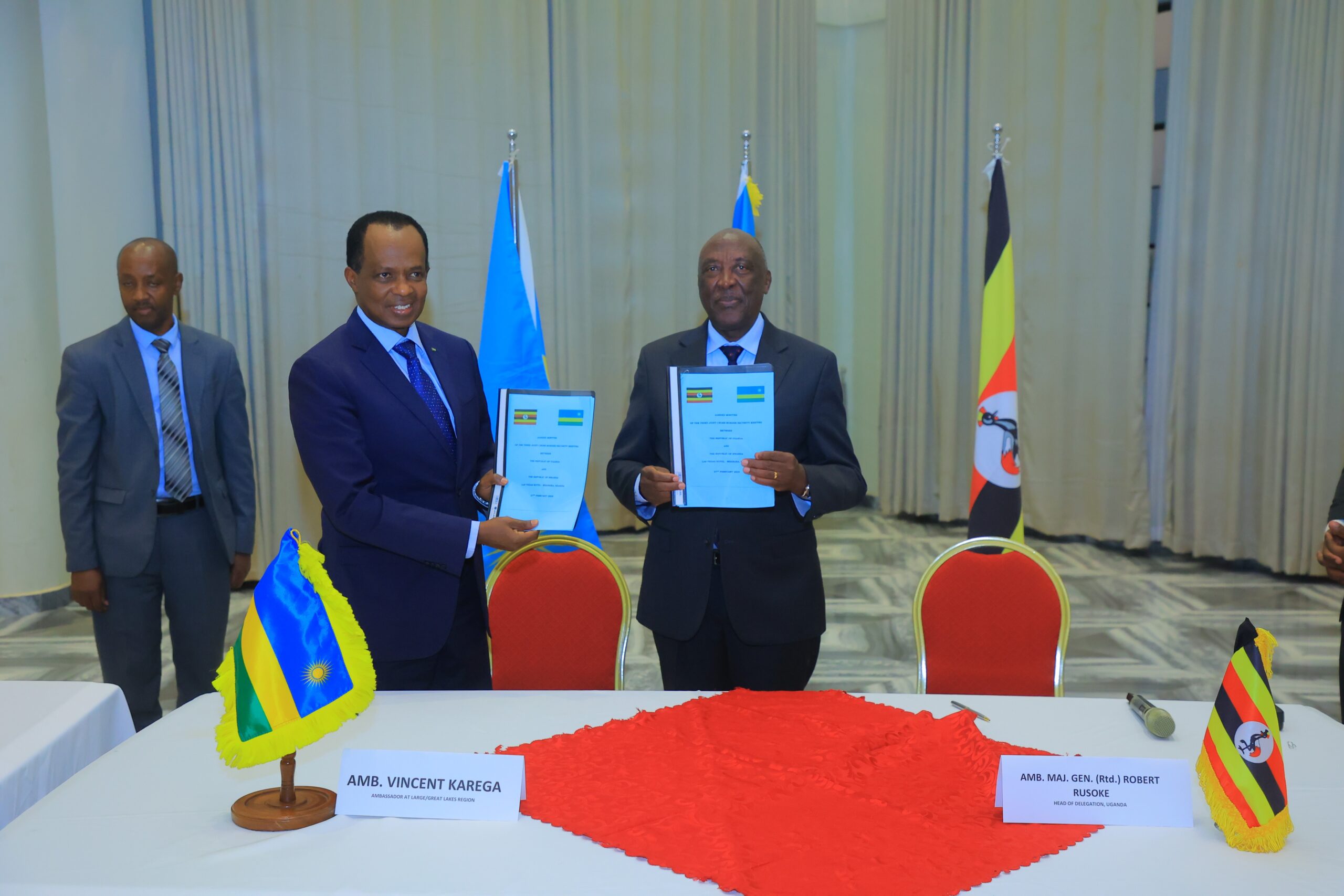 Maj. Gen. (Rtd) Robert Rusoke (right), Uganda's High Commissioner to Rwanda, and Ambassador Vincent Karega, Rwanda's Envoy to the Great Lakes Region, sign a joint communique? in Mbarara, Uganda