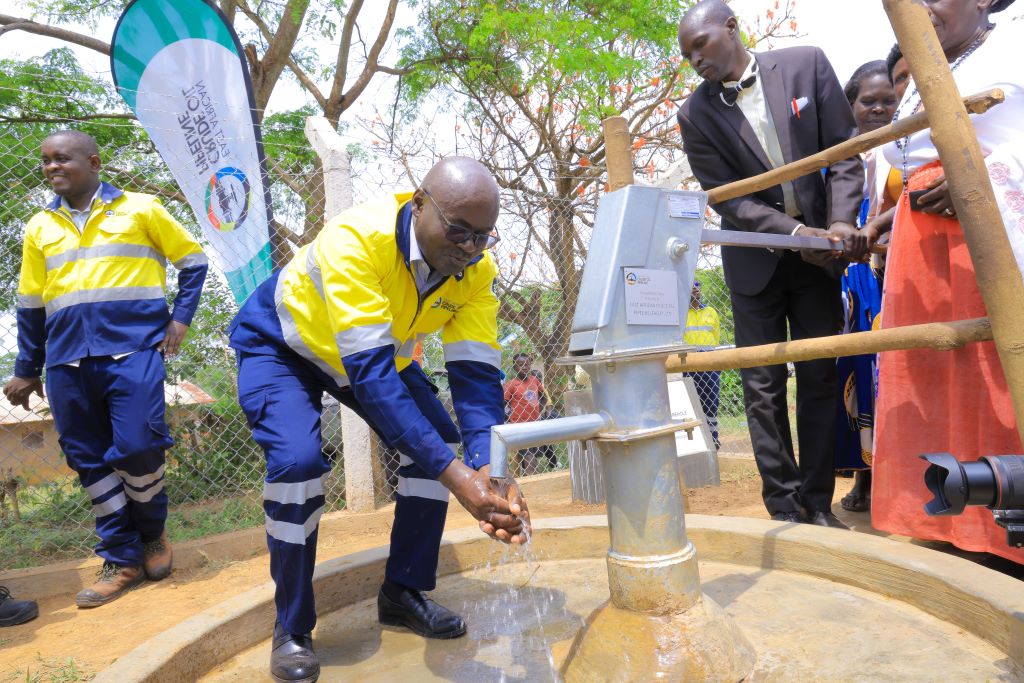 EACOP's Deputy Managing Director & GM Uganda, John Bosco Habumugisha, demonstrates the impact of EACOP's community initiatives as he washes his hands at a newly commissioned borehole, handed over to communities today. This milestone marks the provision of clean, safe water for approximately 3,600 people across 600 households, alleviating water scarcity in the region