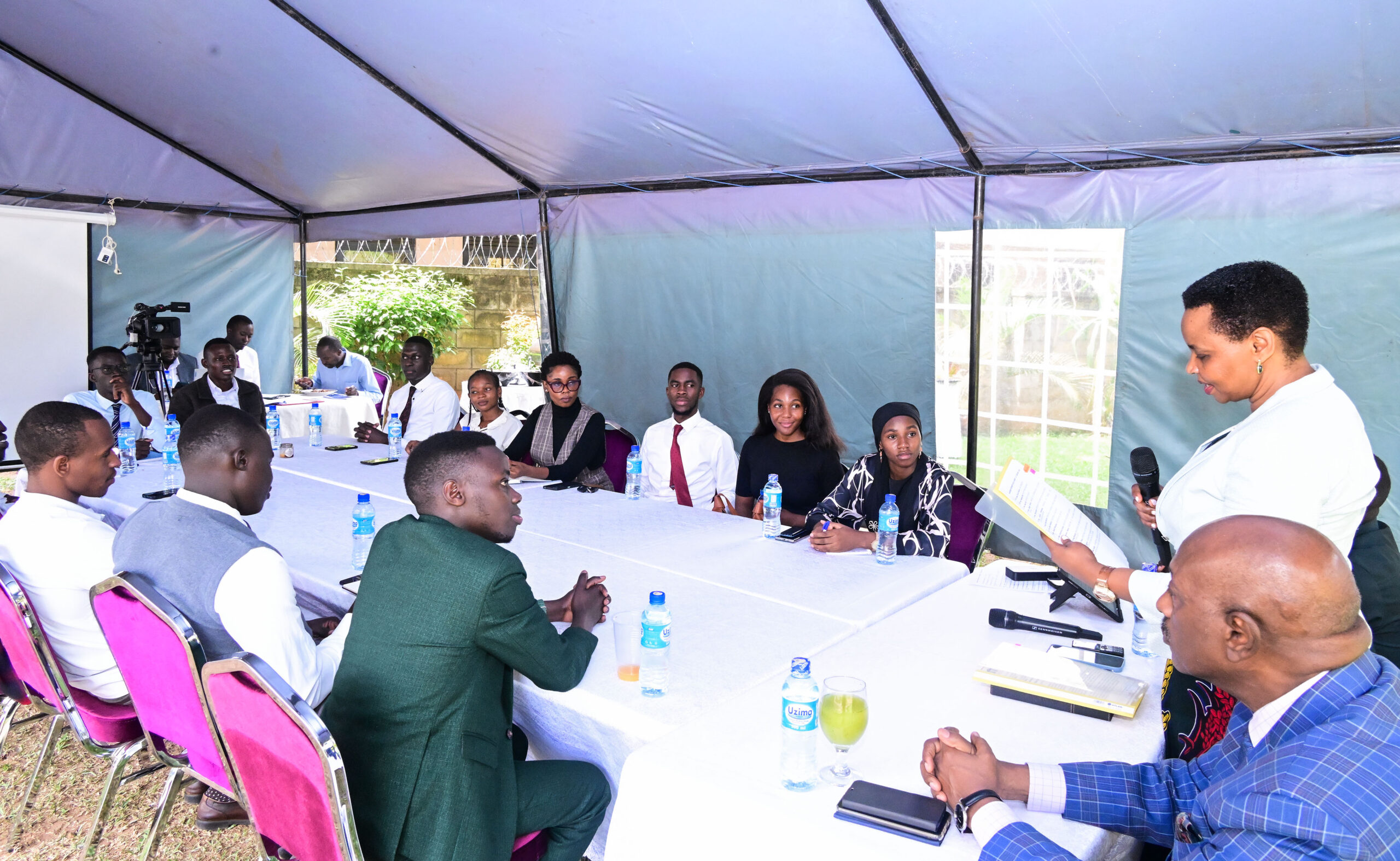 State House Investors Protection Unit boss Col. Edith Nakalema talking to Makerere University Guild President Vincent Lubega Nsamba (L) and his cabinet at her offices at Nakasero on Friday Jan 31.