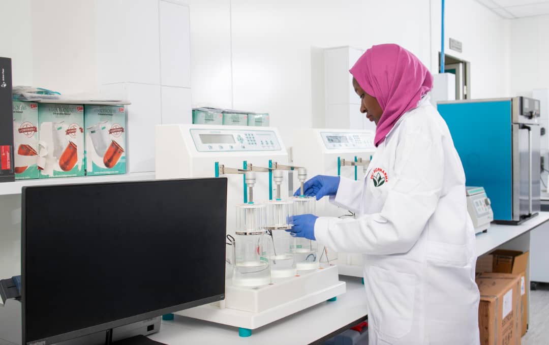 A scientist at Dei BioPharma's state-of-the-art laboratory facility in Matugga, Uganda, carefully examines a sample as part of the company's groundbreaking work in developing and manufacturing essential medicines and vaccines.