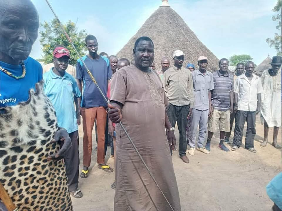 Dr Benjamin Bol Mel, holding spear, during a meeting with cultural and spiritual leaders last week.