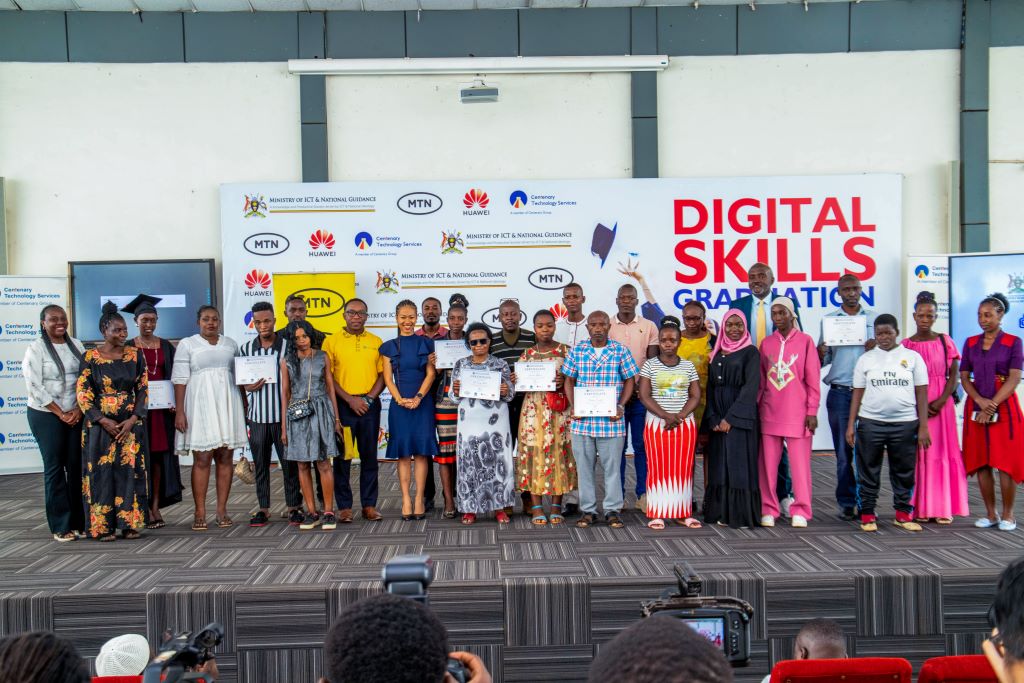 Some of the graduating market vendors pose for a picture with officials from Ministry of ICT, MTN, Huawei, Centenary & Innovation Hub