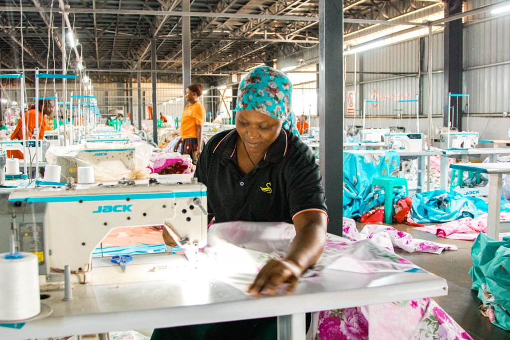 Angella Rose Akurut, a single mother working at Grace Textiles, has turned her life around through her job, launching a successful shoe business and providing for her child after facing numerous challenges